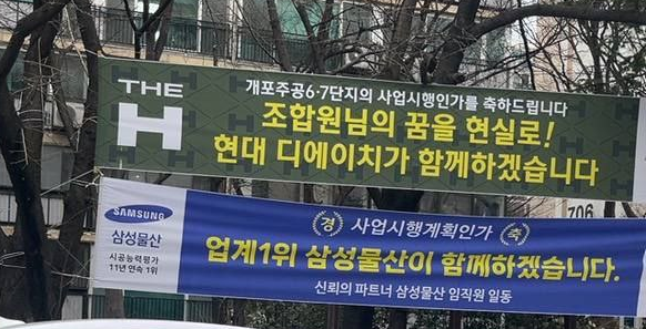 현대건설과 삼성물산이 개포주공 6·7단지에 개첨한 현수막./조합원